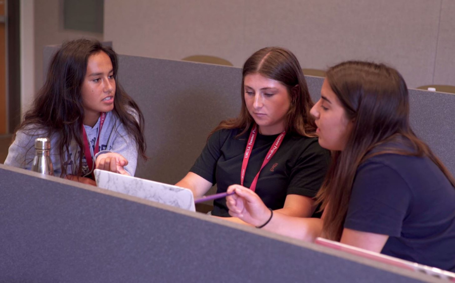 Three students work on an engineering project at LMU